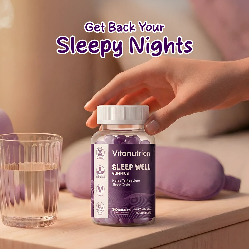 Vitanutrition Sleep Well gummies bottle on a table with a glass of water and purple pillows.